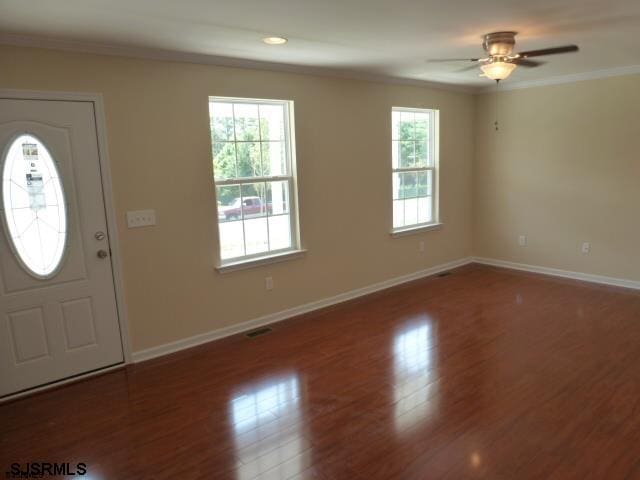 entryway featuring ceiling fan, ornamental molding, and dark hardwood / wood-style floors