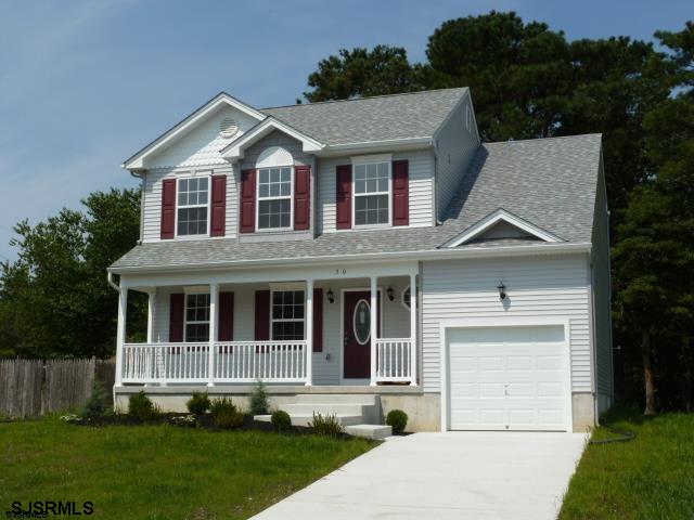 view of front of house featuring covered porch and a front lawn