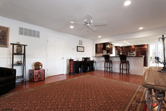 living room featuring dark hardwood / wood-style floors and ceiling fan