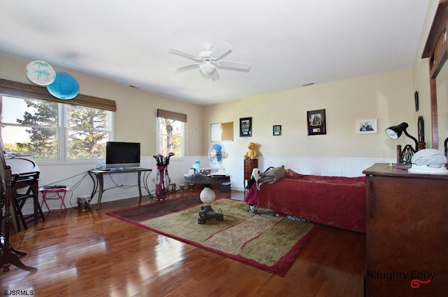 living room with ceiling fan and dark hardwood / wood-style flooring