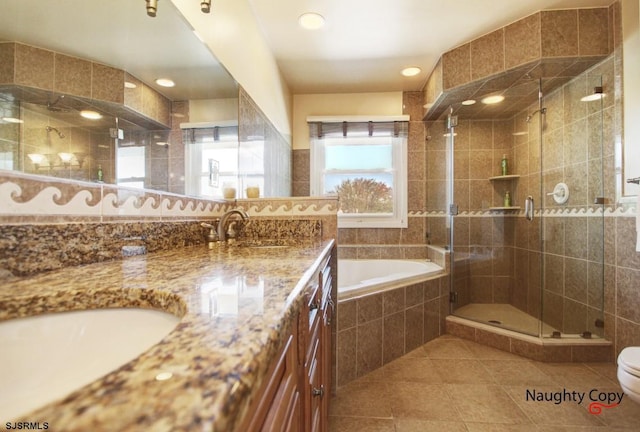 full bathroom featuring tile walls, double sink vanity, tile flooring, toilet, and separate shower and tub