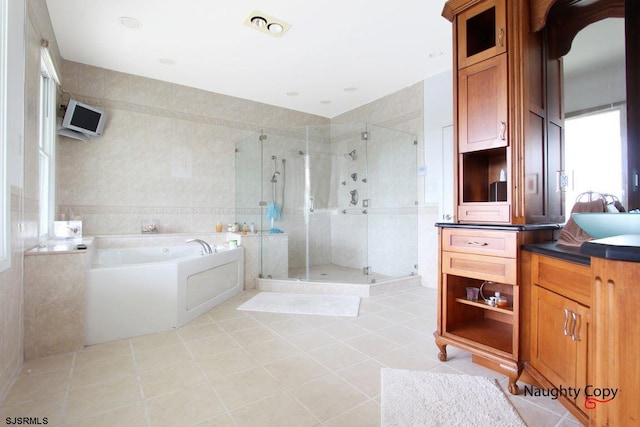 bathroom with shower with separate bathtub, tile floors, and sink