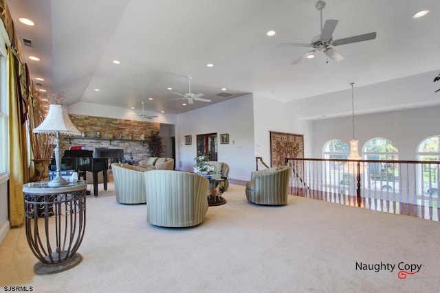 living room featuring ceiling fan, lofted ceiling, a fireplace, and light carpet