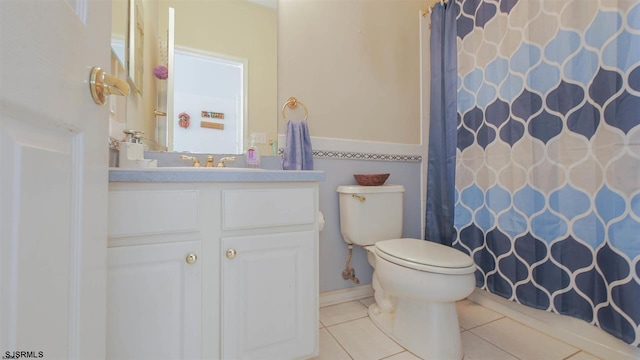 bathroom with oversized vanity, tile flooring, and toilet