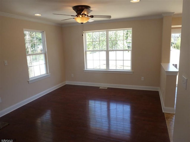 unfurnished room featuring ceiling fan, dark wood-type flooring, and a healthy amount of sunlight