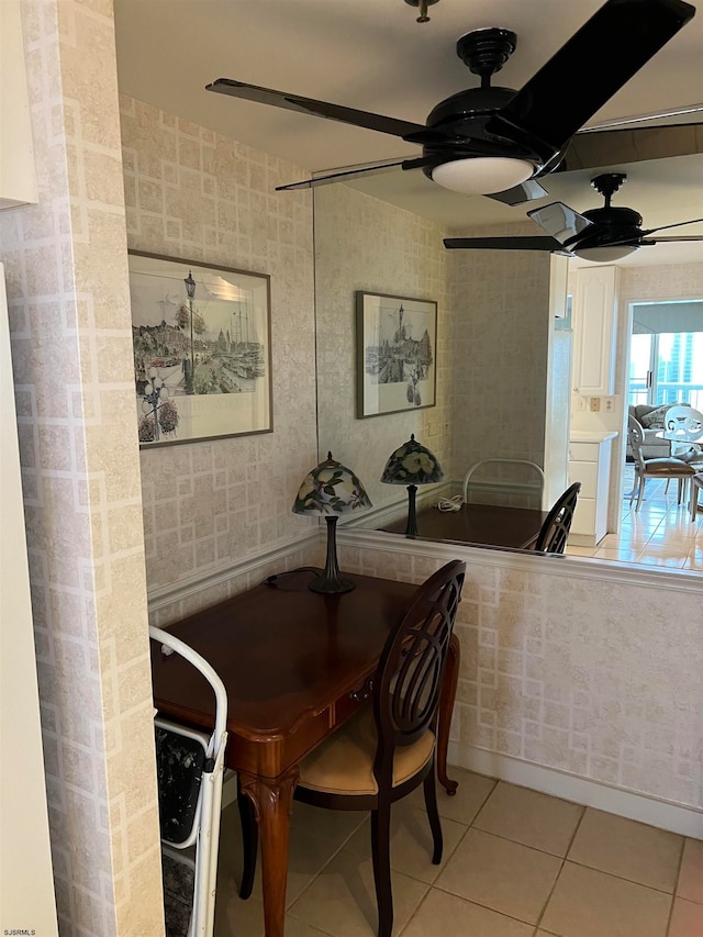 tiled dining area with ceiling fan