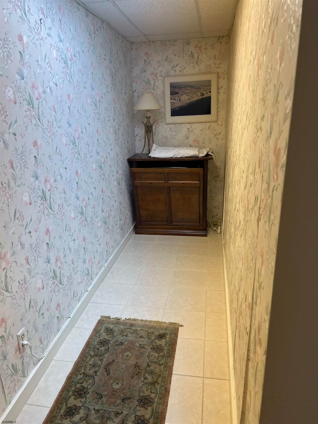 bathroom with tile patterned floors, a drop ceiling, and vanity