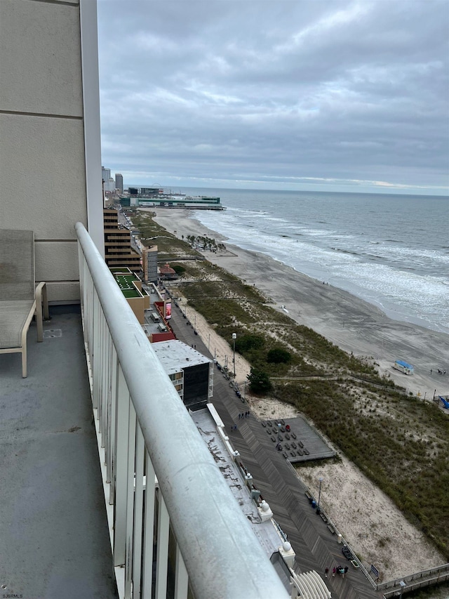 balcony featuring a water view and a view of the beach