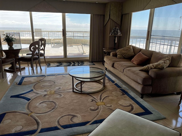 tiled living room featuring a water view