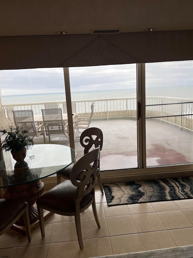 interior space with a water view and a balcony