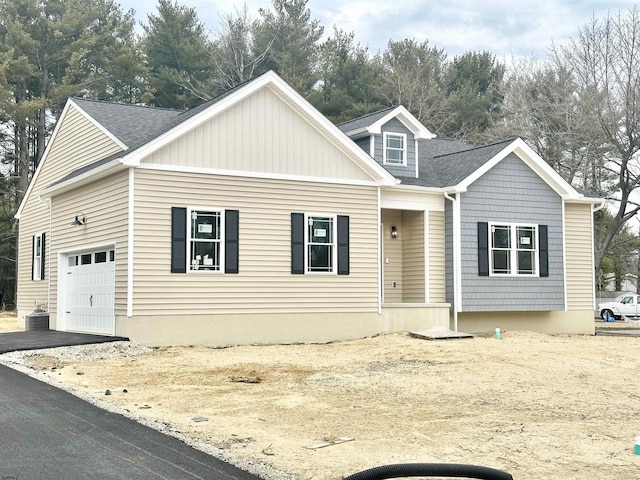 view of front of house featuring roof with shingles and an attached garage