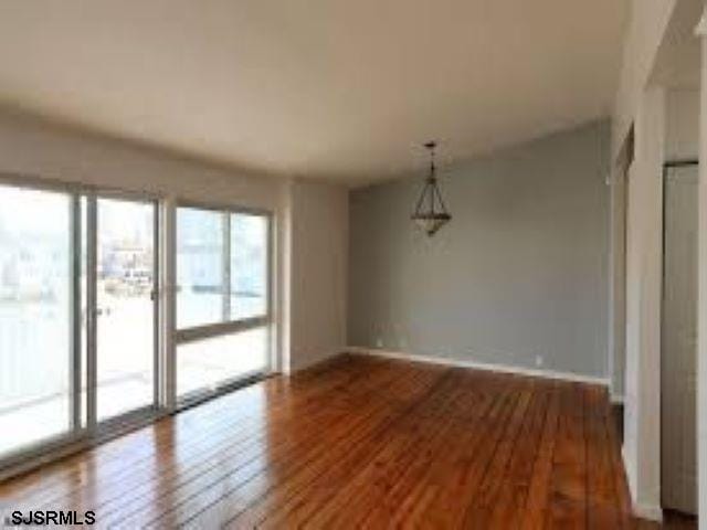 unfurnished room featuring hardwood / wood-style flooring