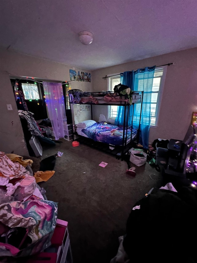 bedroom featuring a textured ceiling and carpet flooring