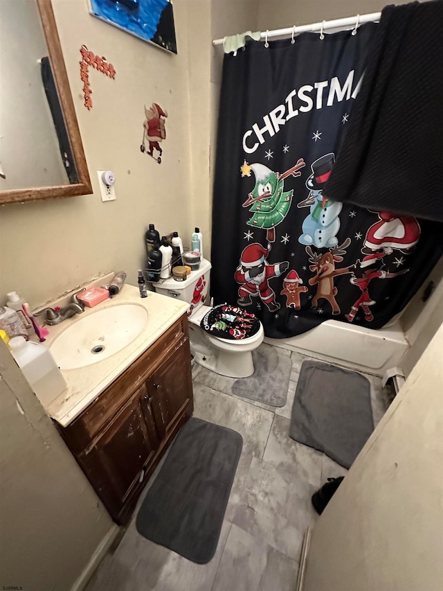 bathroom with vanity, toilet, and tile flooring