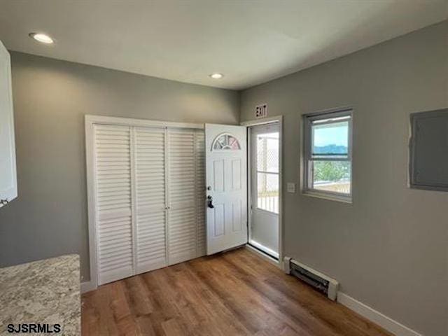 foyer featuring a baseboard radiator and hardwood / wood-style floors