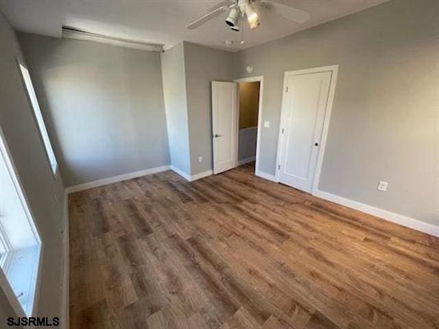 unfurnished bedroom with ceiling fan and hardwood / wood-style flooring