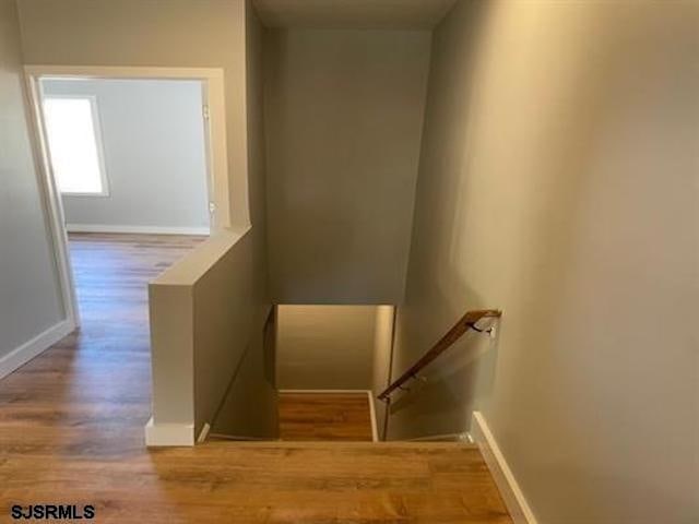 stairway featuring hardwood / wood-style flooring