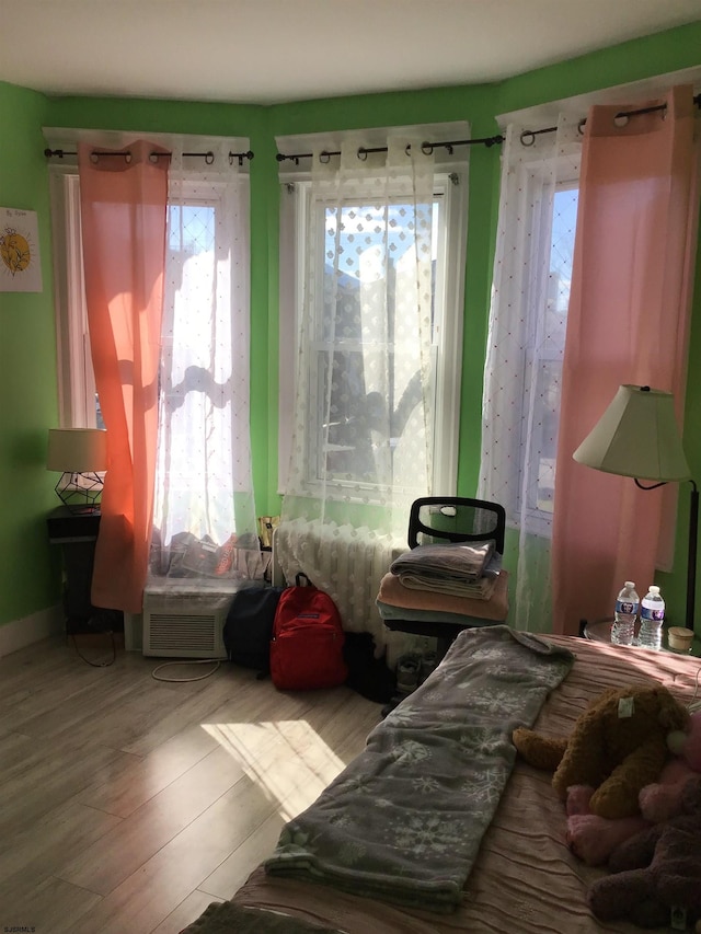 bedroom featuring light hardwood / wood-style floors and multiple windows