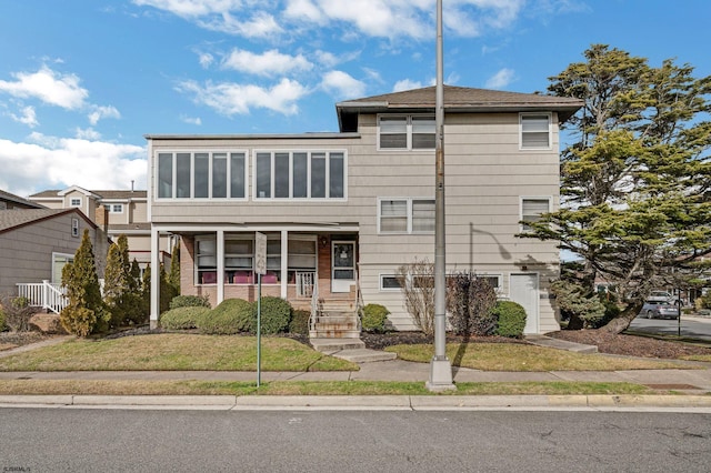 view of front of home with covered porch and a front yard