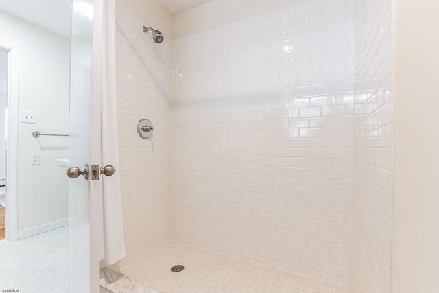 bathroom with a tile shower