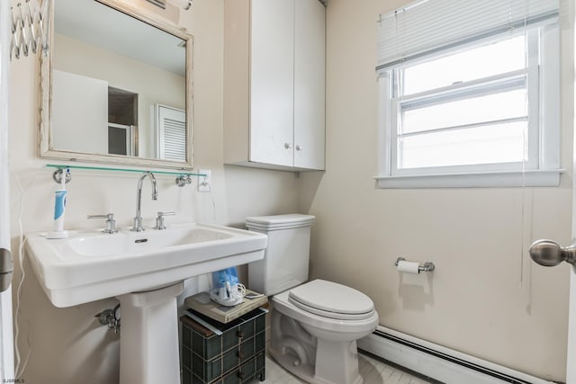 bathroom featuring toilet and a baseboard heating unit