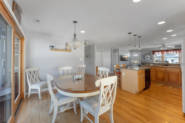 dining area featuring light hardwood / wood-style floors and ceiling fan