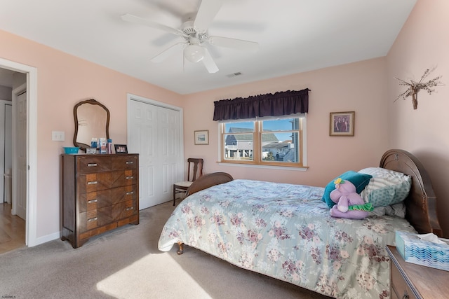 bedroom with ceiling fan, a closet, and light carpet