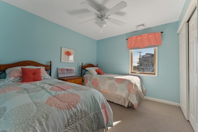 carpeted bedroom with a closet and ceiling fan