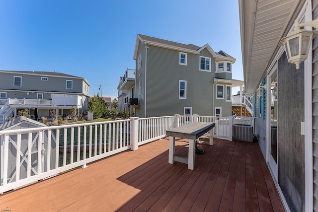 wooden terrace featuring central AC unit