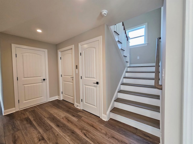 stairway with hardwood / wood-style floors