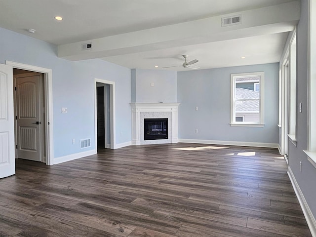 unfurnished living room with ceiling fan and dark wood-type flooring