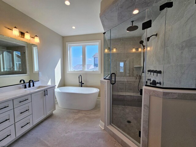 bathroom featuring vanity and shower with separate bathtub