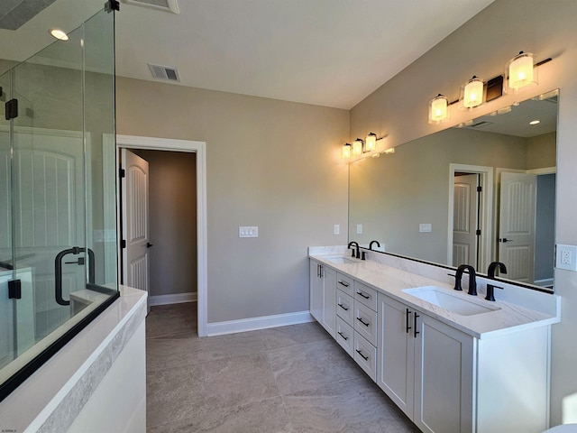 bathroom with tile patterned floors, a shower with door, and vanity