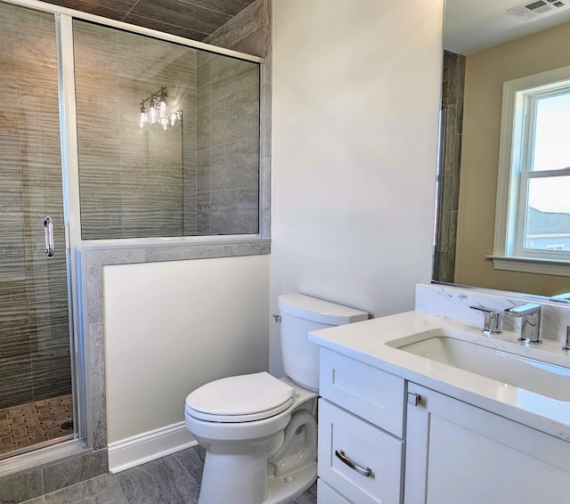 bathroom featuring tile patterned floors, vanity, toilet, and walk in shower