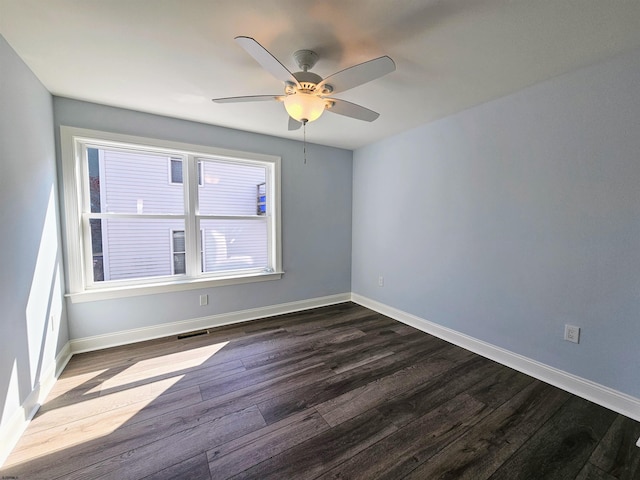 empty room featuring ceiling fan and dark hardwood / wood-style floors