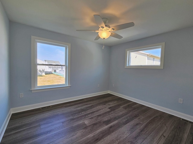 spare room with ceiling fan and dark hardwood / wood-style flooring