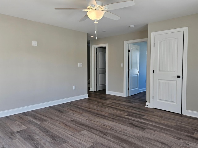 unfurnished bedroom with ceiling fan and dark hardwood / wood-style flooring