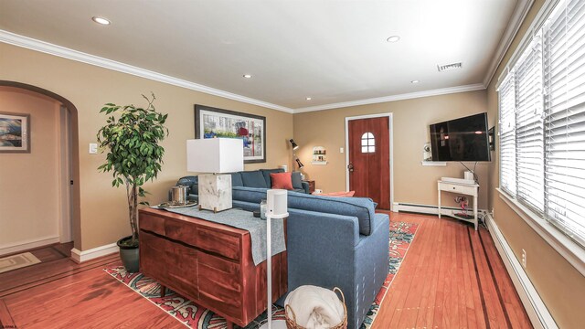 living room with ornamental molding, plenty of natural light, and dark hardwood / wood-style floors