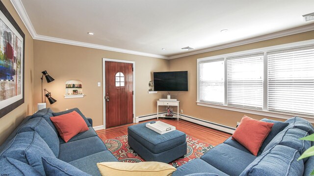 living room featuring crown molding, baseboard heating, and light wood-type flooring