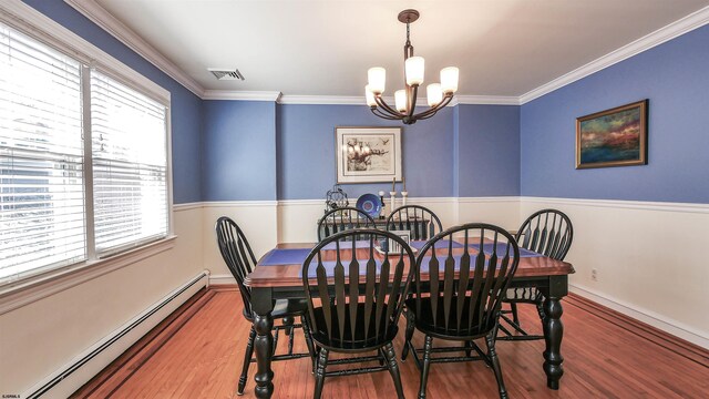 dining space with plenty of natural light, an inviting chandelier, wood-type flooring, and a baseboard heating unit