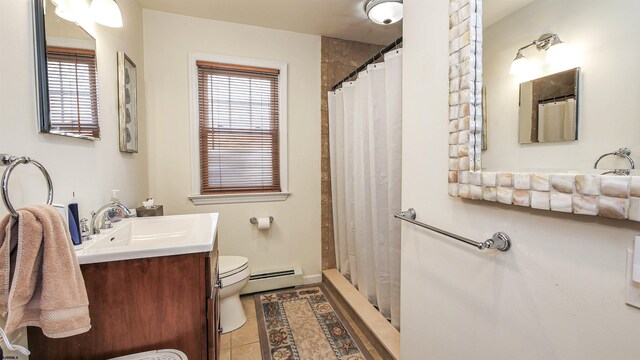 bathroom with vanity, tile flooring, a baseboard radiator, and toilet