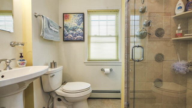 bathroom with baseboard heating, tile flooring, toilet, a shower with door, and sink