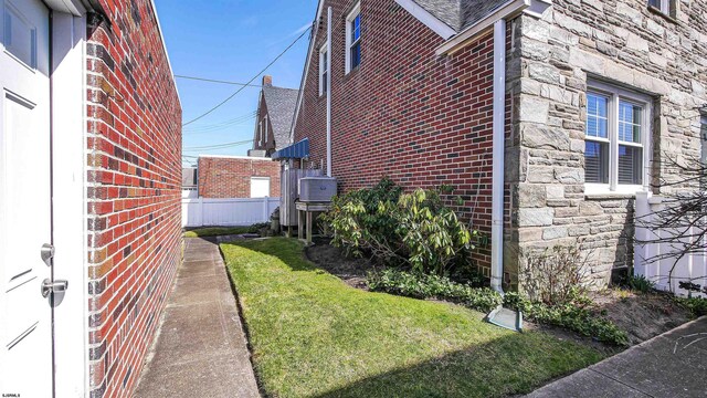 view of side of home featuring a yard