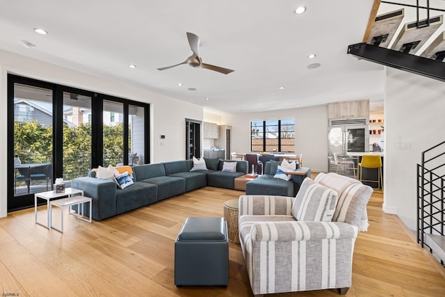 living room featuring french doors, light hardwood / wood-style floors, and ceiling fan