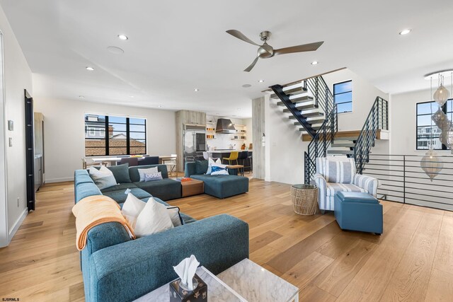 living room featuring light hardwood / wood-style floors and ceiling fan