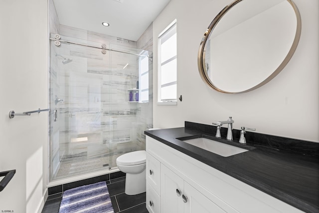 bathroom featuring tile flooring, vanity with extensive cabinet space, an enclosed shower, and toilet