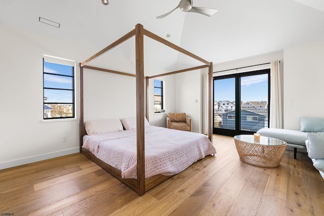 bedroom featuring access to outside, light hardwood / wood-style floors, ceiling fan, and multiple windows