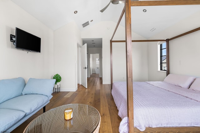 bedroom featuring ceiling fan, hardwood / wood-style floors, and vaulted ceiling