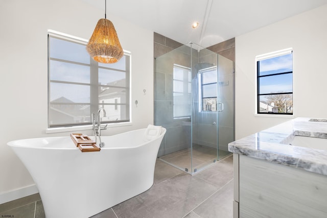 bathroom with tile flooring, vanity, and separate shower and tub