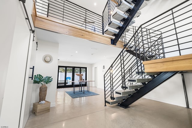 staircase with a towering ceiling